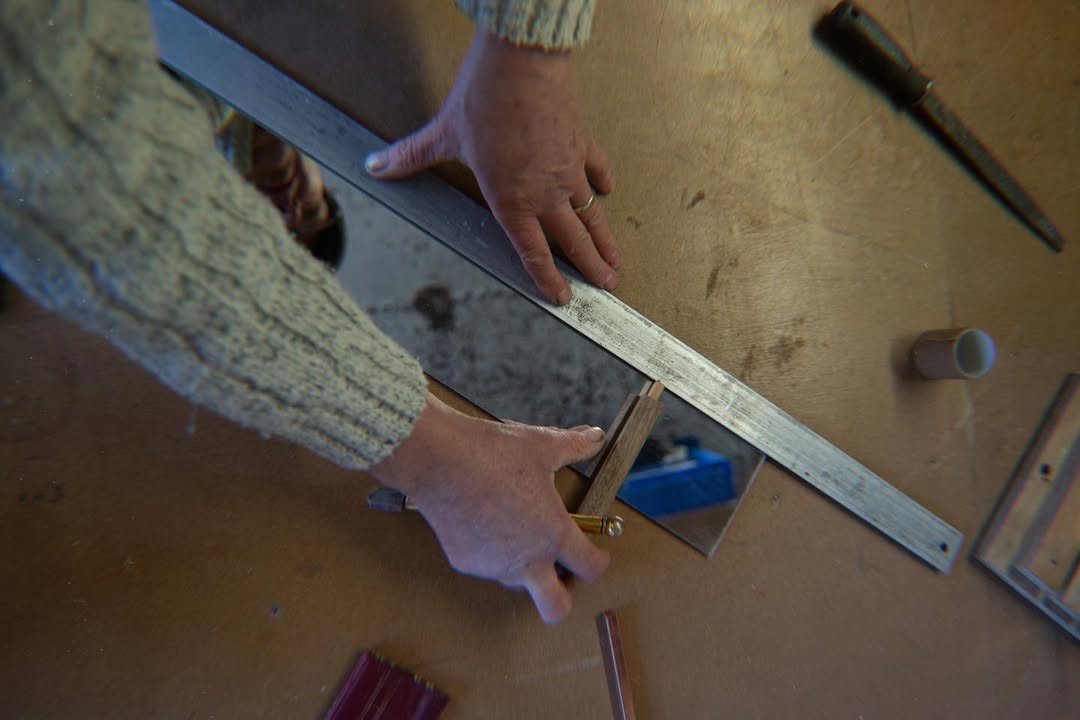 Hand-cutting glass in the studio